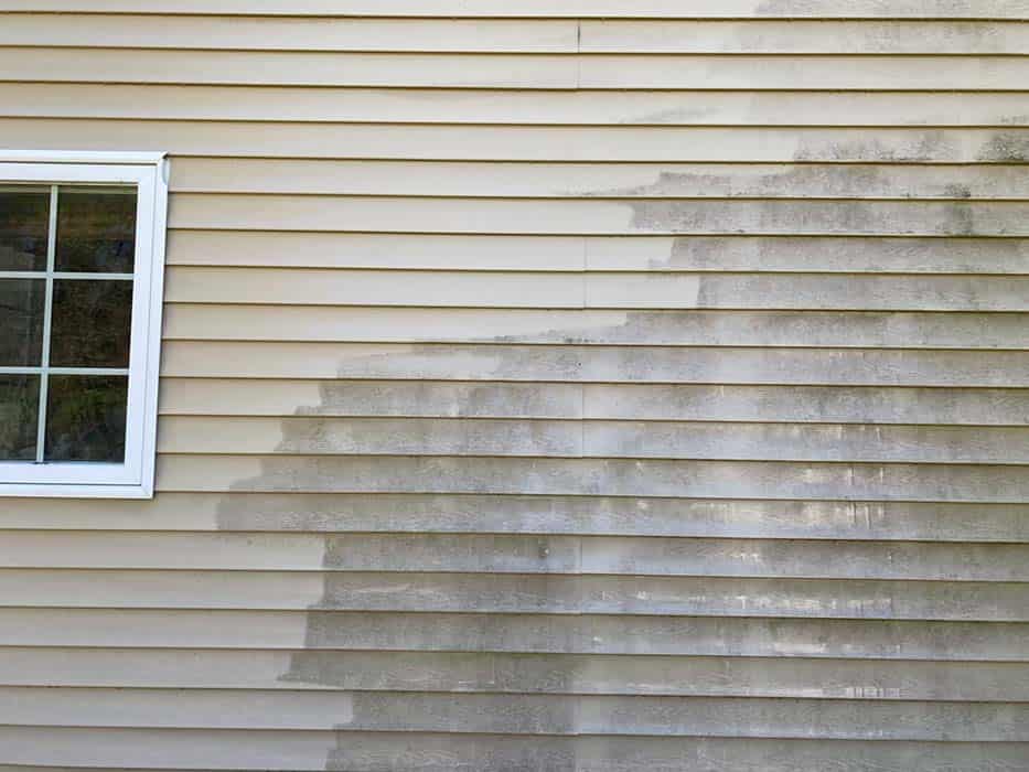 Powerwashing house in progress, showing before and after.
